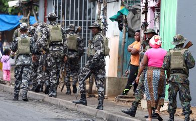 FILE PHOTO: A member of the Mozambique military, looks on as they patrol the streets of the capital a day after a 