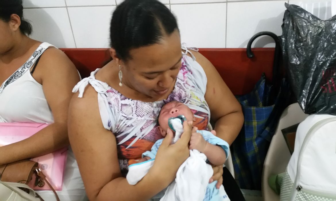 Jakeline Maria da Silva, moradora de Porto de Galinhas (PE), carrega o pequeno Gustavo Henrique, de 2 meses (Sumaia Villela/Agência Brasil)