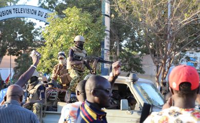 People show their support for the military after they deposed President Kabore outside state Television RTB headquarter, in Ouagadougou