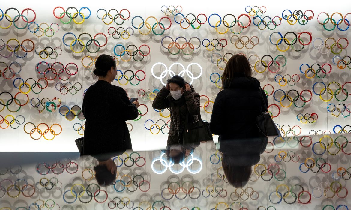 People wearing protective face masks, following an outbreak of the coronavirus, are seen at The Japan Olympics museum in Tokyo