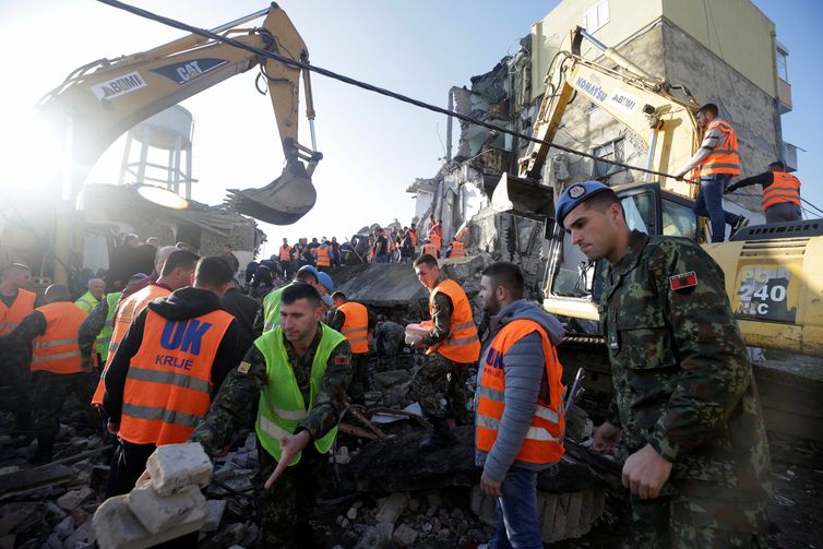 Emergency personnel work near a damaged building in Thumane, after an earthquake shook Albania, November 26, 2019. REUTERS/Florion Goga