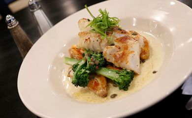 Baked codfish with lemon caper sauce, broccolini and fingerling potatoes at Mad Hatter in Weymouth on Wednesday, Jan. 26,