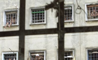 BRAZILIAN PRISONERS LOOK OUT FROM THEIR CELL AT CARANDIRU PRISON.