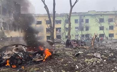 A view shows cars and a building of a hospital destroyed by aviation strike in Mariupol