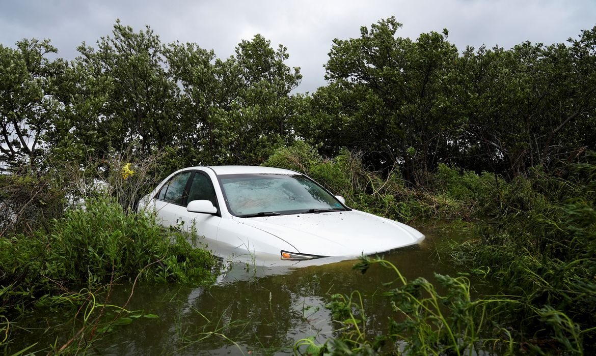 Veículo fica parcialmente submerso após apassagem do furacão Idalia, em Cedar Key, Flórida