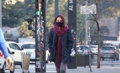 Pessoas saem agasalhadas em São Paulo, que registra baixas temperaturas por causa de uma frente fria.