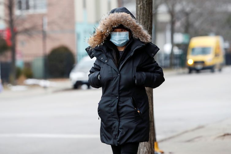 FILE PHOTO: A woman wears a mask in Chinatown following the outbreak of the novel coronavirus, in Chicago, Illinois, U.S. January 30, 2020. REUTERS/Kamil Krzaczynski/File Photo