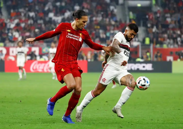 Soccer Football - Club World Cup - Final - Liverpool v Flamengo - Khalifa International Stadium, Doha, Qatar - December 21, 2019  Liverpool&#039;s Virgil van Dijk in action with Flamengo&#039;s Gabriel Barbosa   REUTERS/Corinna Kern