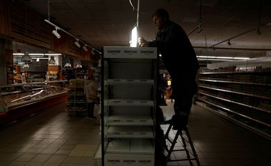 FILE PHOTO: People shop during an electricity outage, in Kharkiv