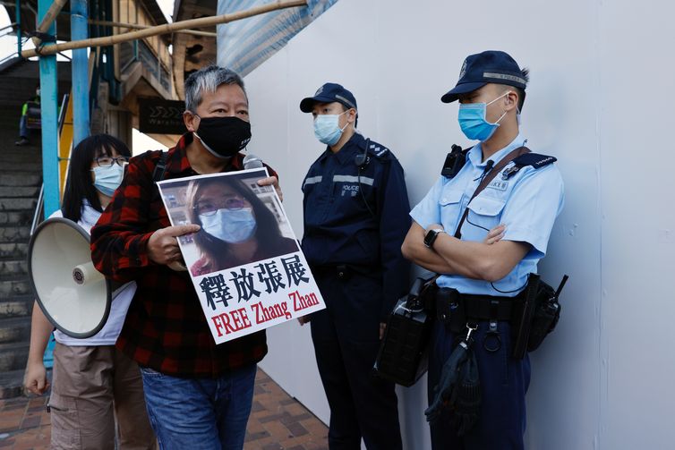 Pro-democracy supporters protest to urge for the release of 12 Hong Kong activists arrested as they reportedly sailed to Taiwan for political asylum and citizen journalist Zhang Zhan outside China's Liaison Office, in Hong Kong