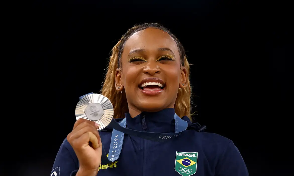 Paris 2024 Olympics - Artistic Gymnastics - Women's All-Around Victory Ceremony - Bercy Arena, Paris, France - August 01, 2024.
Silver medallist Rebeca Andrade of Brazil celebrates on the podium. REUTERS/Hannah Mckay