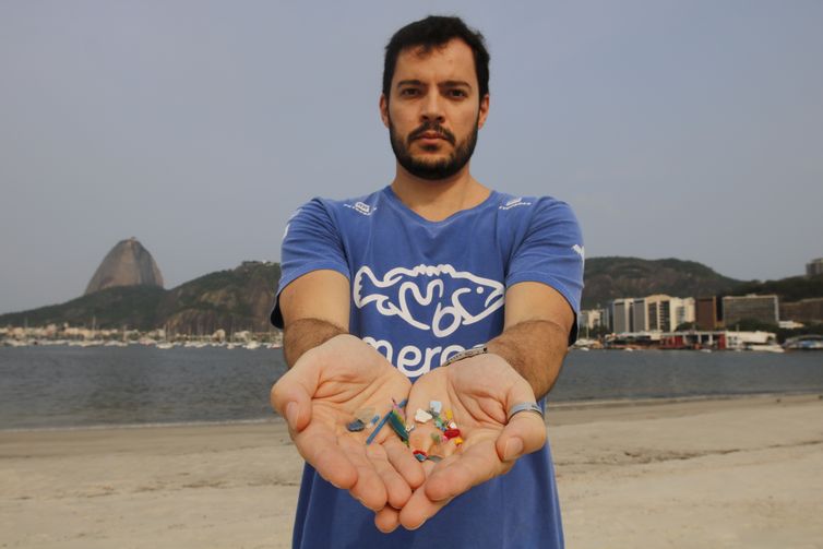 Rio de Janeiro -  O biólogo Jonas Leite, doutor em oceanografia, presidente do Instituto Meros do Brasil, mostra microplástico vindo do mar coletado na areia da praia de Botafogo. (Fernando Frazão/Agência Brasil)
