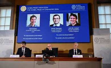 Announcers of the laureates for the Nobel Prize in Chemistry, Johan Aqvist, Hans Ellegren and Heiner Linke, look on as the images of the winners, David Baker (University of Washington, USA), Demis Hassabis (Google DeepMind, UK) and John M Jumper (Google DeepMind, UK) are displayed, in Stockholm, Sweden October 9, 2024. TT News Agency/Christine Olsson via REUTERS      ATTENTION EDITORS - THIS IMAGE WAS PROVIDED BY A THIRD PARTY. SWEDEN OUT. NO COMMERCIAL OR EDITORIAL SALES IN SWEDEN.