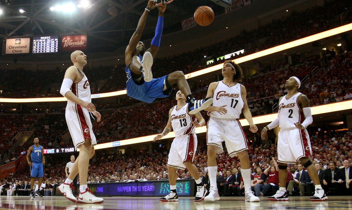 FILE PHOTO: Orlando Magic centre Dwight Howard knocks the 24-second clock off the backboard with a ferocious dunk during his side's 107-106 victory against Cleveland Cavaliers in Game 1 of their Eastern Conference Final playoff game
