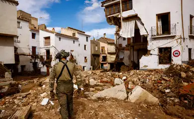 A member of Spanish UME military unit walks on the debris after heavy rains caused flooding, in Letur, Spain, October 30, 2024. REUTERS/Susana Vera