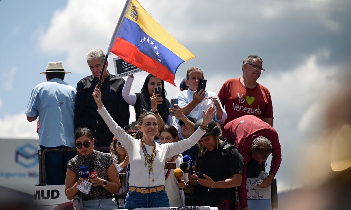 Venezuelan opposition leader Maria Corina Machado holds a flag as she leads a march amid the disputed presidential election, in Caracas, Venezuela, August 17, 2024. Reuters/Gaby Oraa/Proibida reprodução