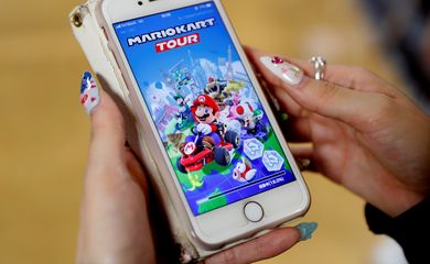 A woman shows the mobile title Mario Kart Tour on her smartphone during an interview with Reuters at Tatio's game center in Tokyo, Japan September 25, 2019. REUTERS/Kim Kyung-Hoon