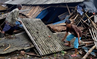 Residents collect debris from their collapsed house after it was hit by a tsunami at Panimbang district in Pandeglang, Banten province, Indonesia, December 23, 2018, in this photo taken by Antara Foto.  Antara Foto/Muhammad Bagus Khoirunas/ via