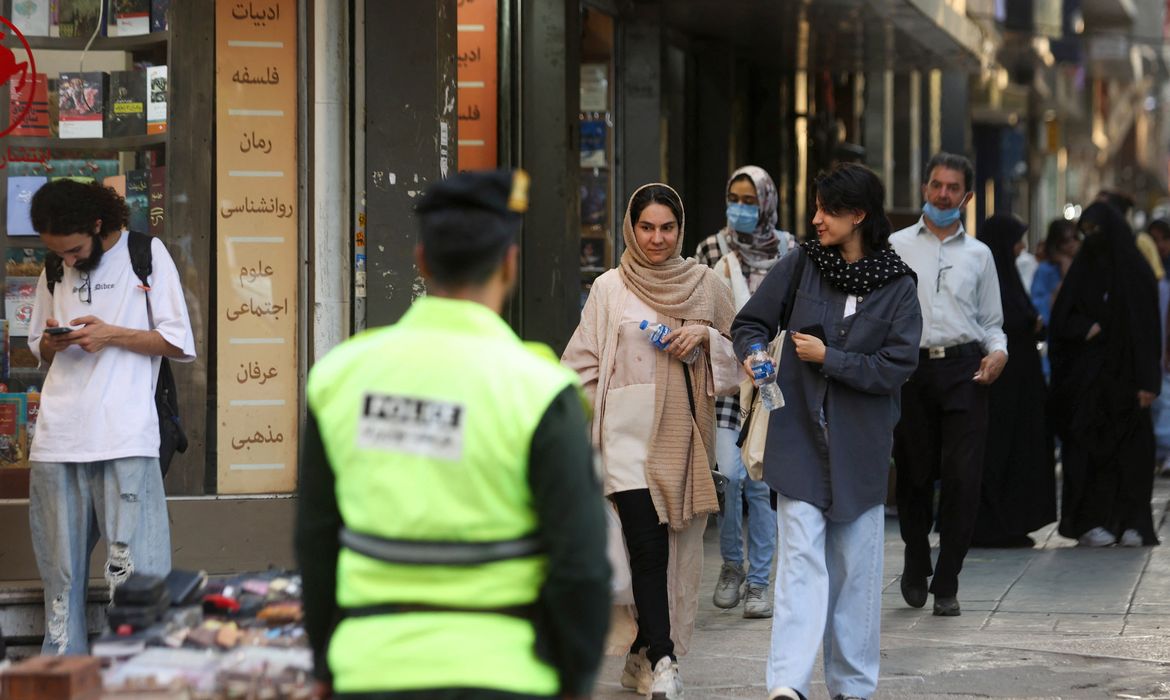 Iranian women walk on a street during the revival of morality police in Tehran, Iran, July 16, 2023. Majid Asgaripour/WANA