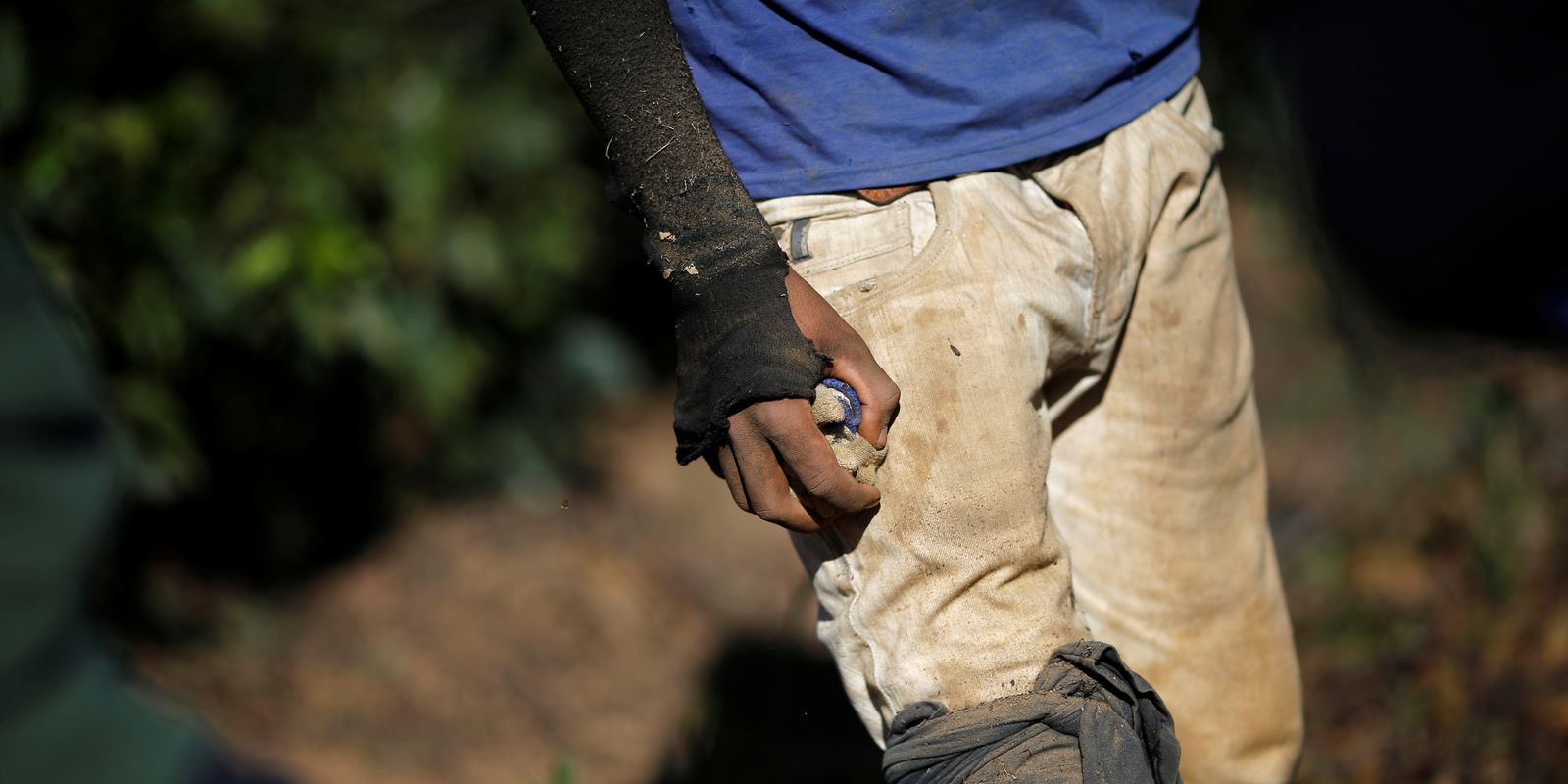 Worker is seen in a coffee farm during a labor ministry operation to identify workers in conditions analogous to slavery, in Campos Altos