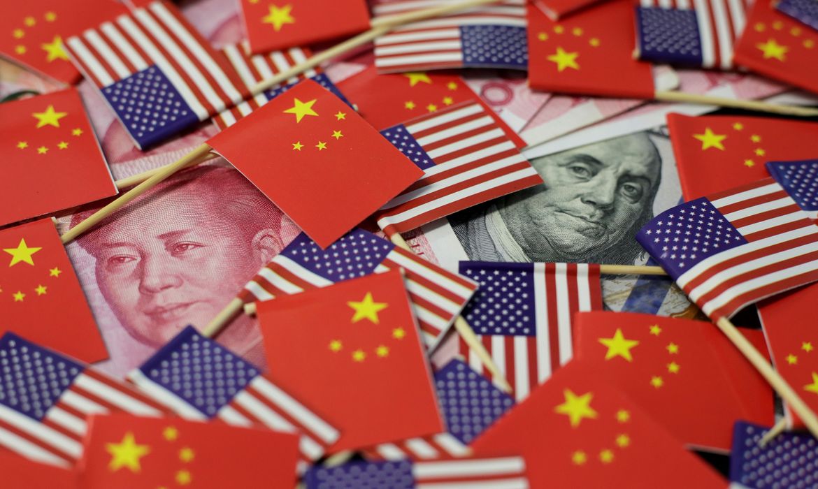 FILE PHOTO: A U.S. dollar banknote featuring American founding father Benjamin Franklin and a China's yuan banknote featuring late Chinese chairman Mao Zedong are seen among U.S. and Chinese flags in this illustration picture taken May 20, 2019.