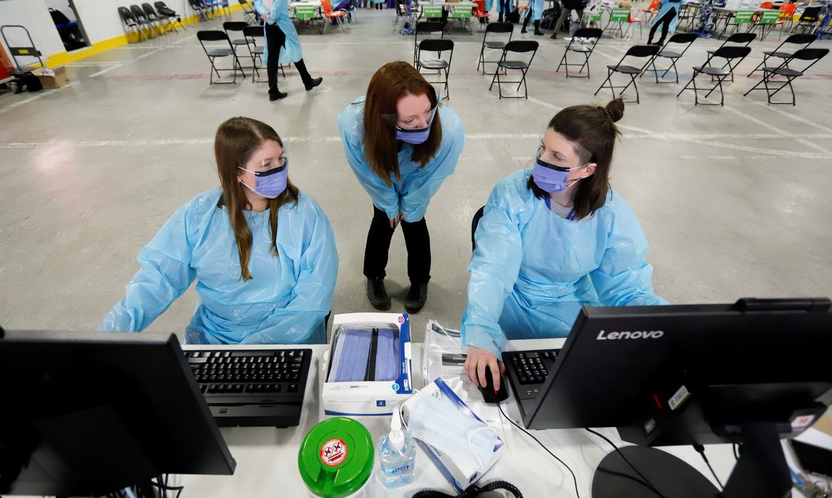 Medical staff members prepare to receive patients for coronavirus screening at a temporary assessment center at the Brewer hockey arena in Ottawa