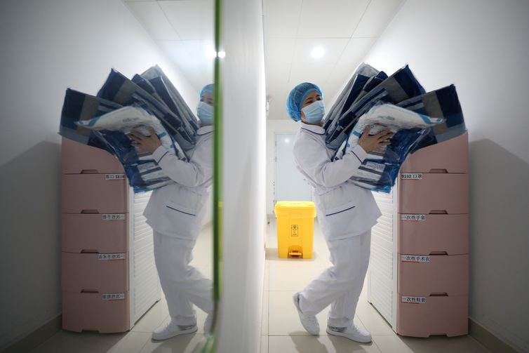 Medical worker carries protective suits at Jinyintan hospital in Wuhan, the epicentre of the novel coronavirus outbreak