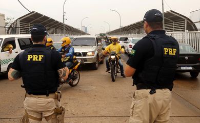 Policiais Rodoviários Federais controlam o fluxo de veículos na Ponte da Amizade Internacional que liga seu país ao Paraguai, que ficou fechada por meses devido ao surto da doença coronavírus (COVID-19) em Foz do Iguaçu