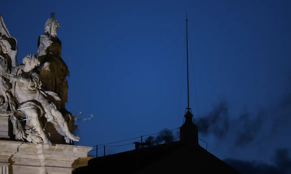 Black smoke rises from the chimney on the Sistine Chapel, indicating no decision has been made to elect a new pope, at the Vatican, May 7, 2025. REUTERS/Murad Sezer