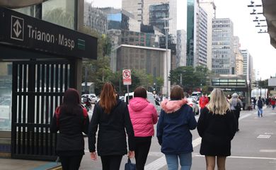 Pedestres na Avenida Paulista durante frente fria.