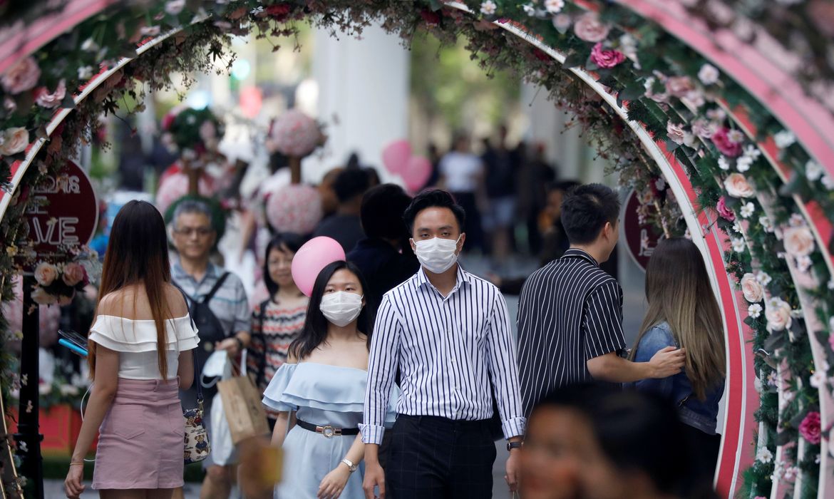 A couple celebrate Valentine's Day as they wear face masks in precaution of the coronavirus outbreak at Orchard Road in Singapore