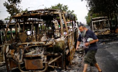 Burned busses are pictured after a protest against the increase in subway ticket prices in Santiago, Chile, October 19, 2019 REUTERS/Edgard Garrido