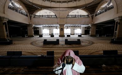 A cleric calls for the prayer at an empty Al-Rajhi Mosque, as Friday prayers were suspended following the spread of the coronavirus disease (COVID-19), in Riyadh
