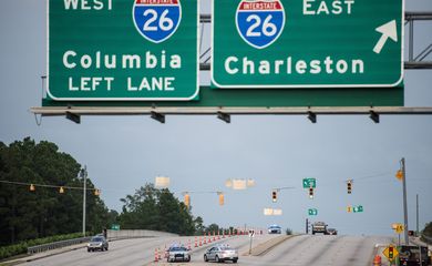 Com a aproximação do Furacão Matthew, agentes rodoviários da Florida organizam o trânsito para permitir a evacuação de milhares de norte-americanos da região