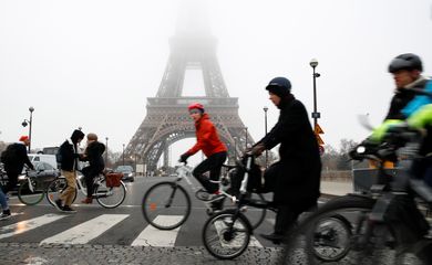 People ride bicycles near the Eiffel Tower during a strike by all unions of the Paris transport network (RATP) as part of a day of national strike and protests against French government's pensions reform plans, France, December 5, 2019.  REUTERS