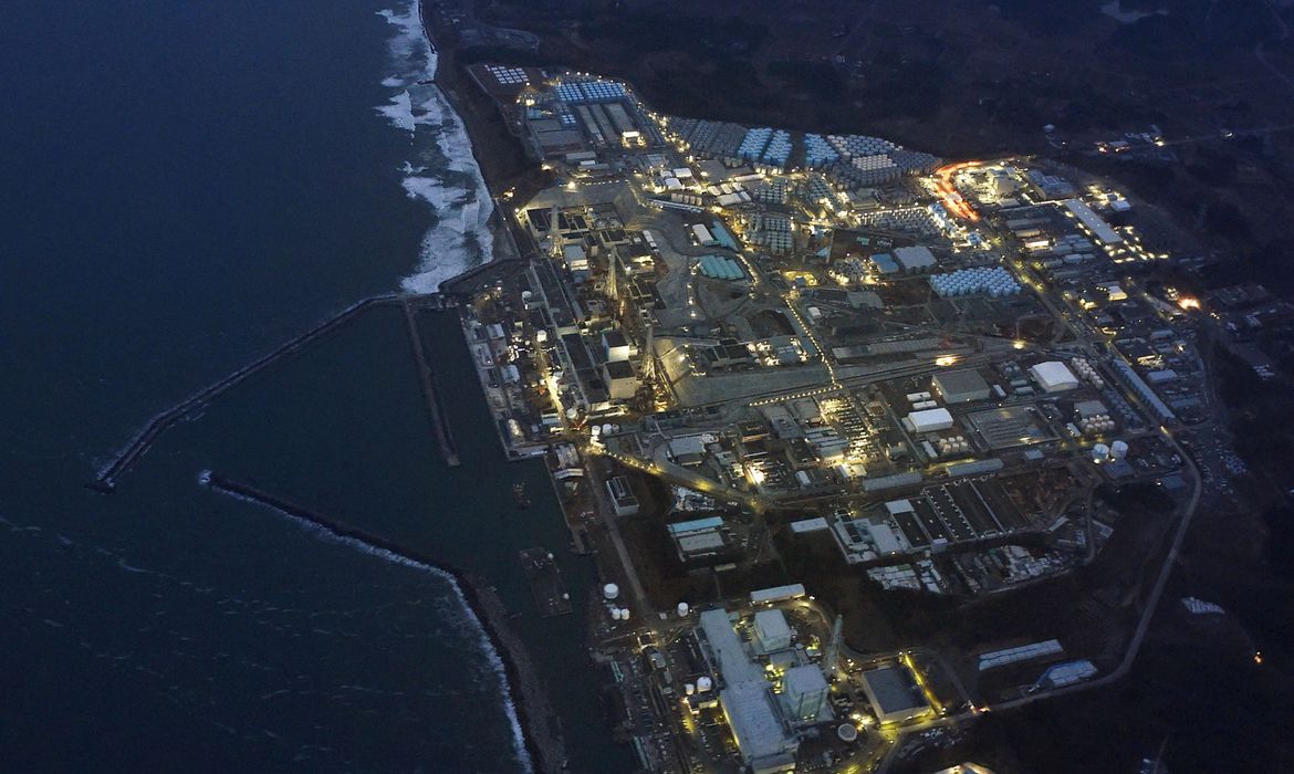 FILE PHOTO: Tokyo Electric Power Co.'s (TEPCO) tsunami-crippled Fukushima Daiichi nuclear power plant is illuminated for decommissioning operation in the dusk in Okuma town, Fukushima prefecture, Japan, in this aerial view photo taken by Kyodo