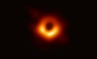 Handout photo of the first ever photo a black hole, taken using a global network of telescopes, conducted by the Event Horizon Telescope (EHT) project