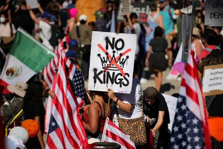 A protester holds a sign reading 