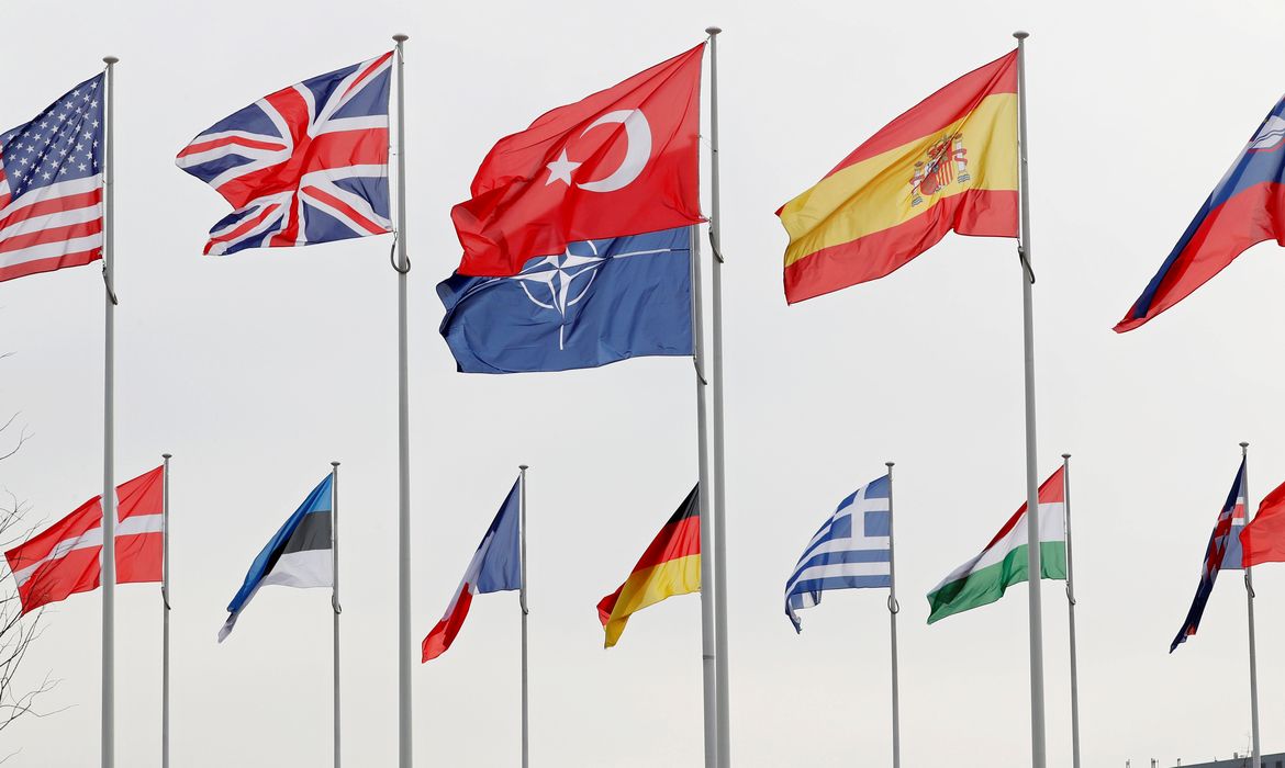 Flags of NATO member countries flutter at the Alliance headquarters in Brussels