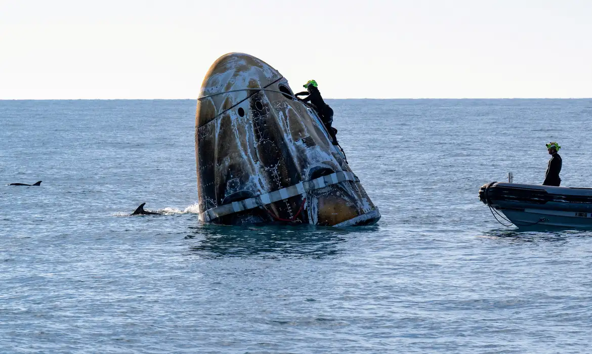 Support teams work around a SpaceX Dragon  spacecraft shortly after it landed with NASA astronauts Nick Hague, Suni Williams, Butch Wilmore, and Roscosmos cosmonaut Aleksandr Gorbunov aboard in the water off the coast of Tallahassee, Florida, Tuesday, March 18, 2025. NASA/Keegan Barber/ Handout via REUTERS