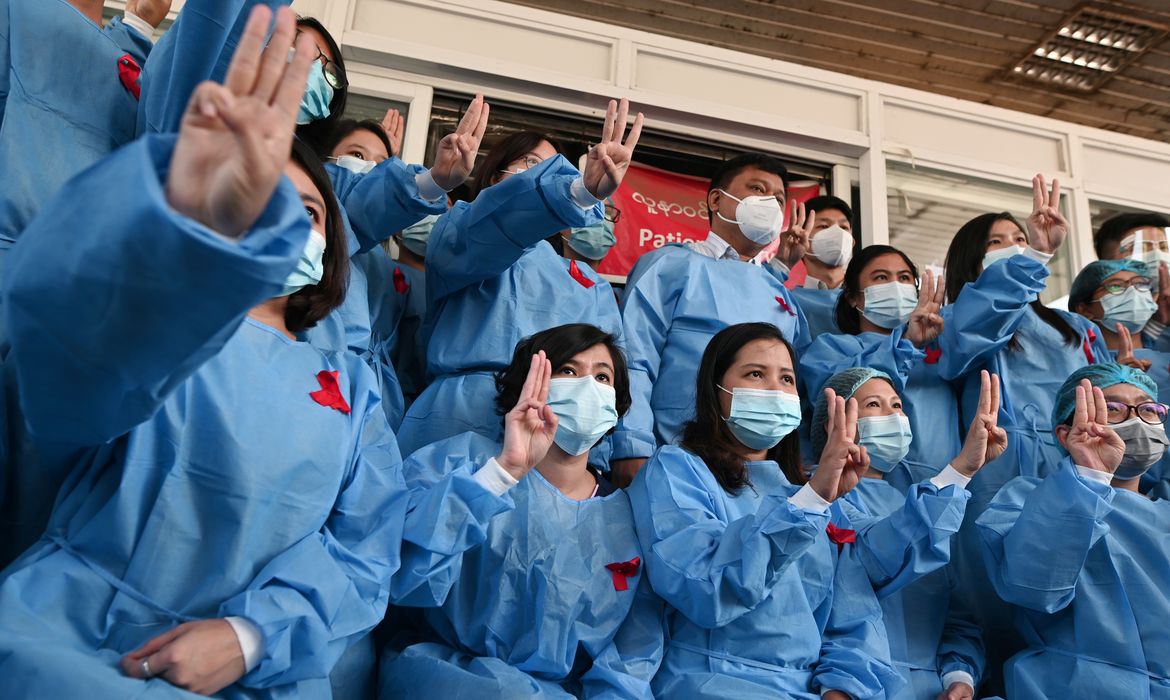 Medical workers wearing red ribbons pose during a protest against the coup that ousted elected leader Aung San Suu Kyi, at Yangon General Hospital, in Yangon