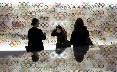 People wearing protective face masks, following an outbreak of the coronavirus, are seen at The Japan Olympics museum in Tokyo