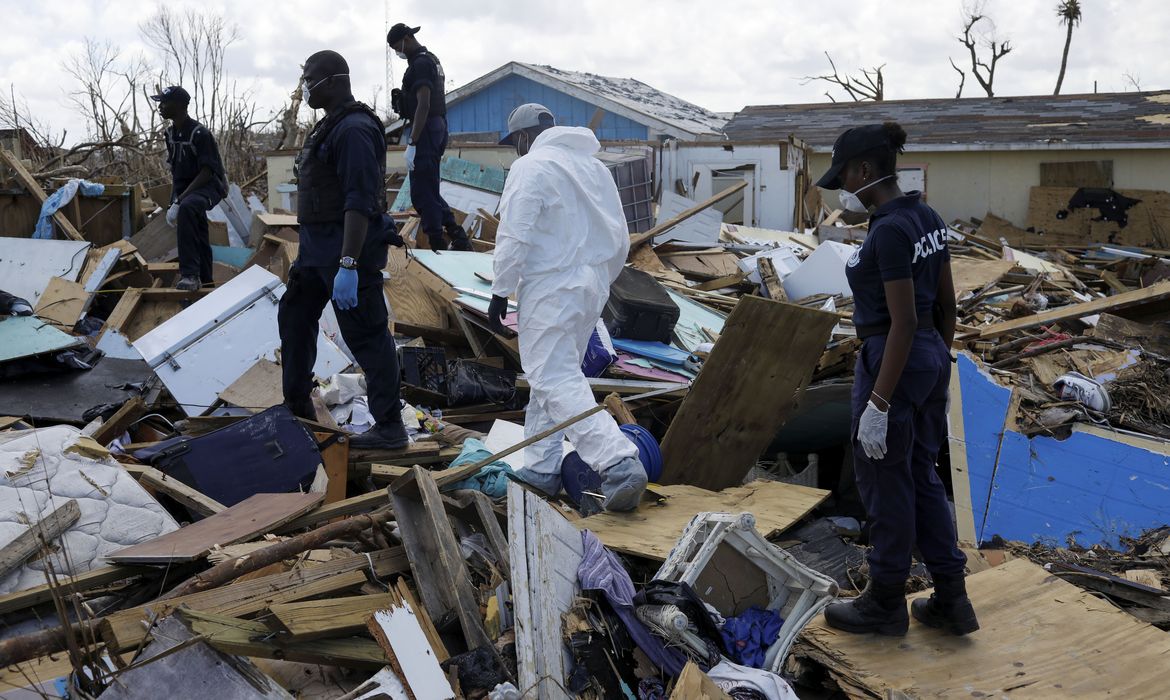 Police officers search for the dead in the destroyed Mudd neighborhood after Hurricane Dorian hit the Abaco Islands in Marsh Harbour, Bahamas, September 10, 2019. REUTERS/Marco Bello