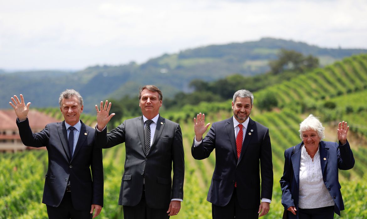 Argentina's President Mauricio Macri, Brazil's President Jair Bolsonaro, Paraguay's President Mario Abdo Benitez and Uruguay's Vice President Lucia Topolansky wave as they pose for a family picture during the Mercosur trade bloc summit, in 