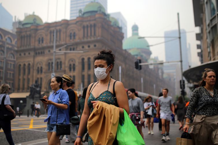 Pedestrians are seen wearing masks as smoke haze from bushfires in New South Wales blankets the CBD in Sydney, Australia, December 10, 2019. AAP Image/Steven Saphore/via REUTERS    ATTENTION EDITORS - THIS IMAGE WAS PROVIDED BY A THIRD PARTY. NO