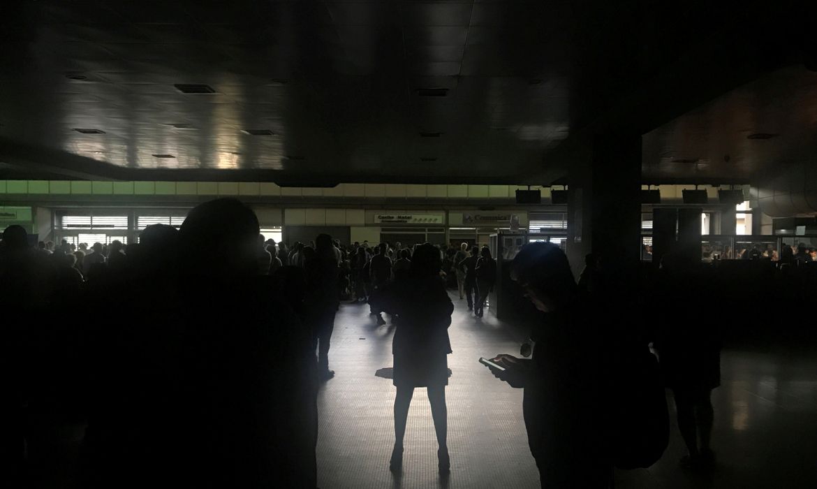 Passageiros durante um apagão no aeroporto internacional Simon Bolivar em Caracas, Venezuela.
