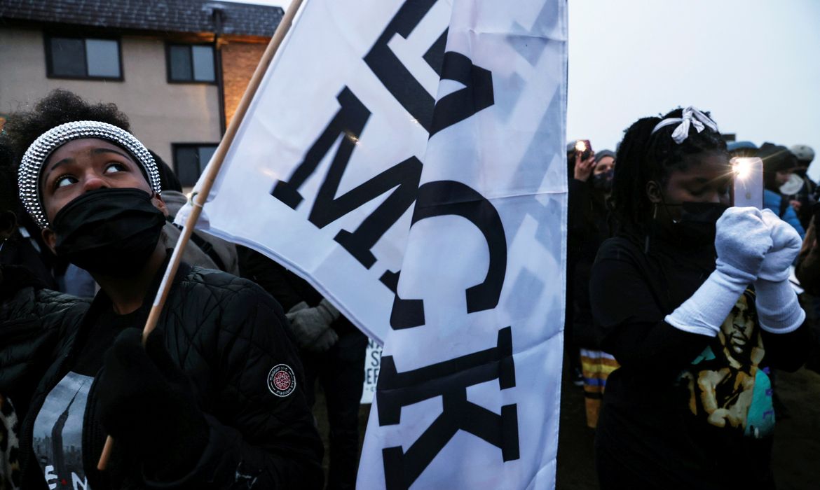 People take part in a rally outside the Brooklyn Center Police Department, days after Daunte Wright was shot and killed by a police officer, in Brooklyn Center, Minnesota