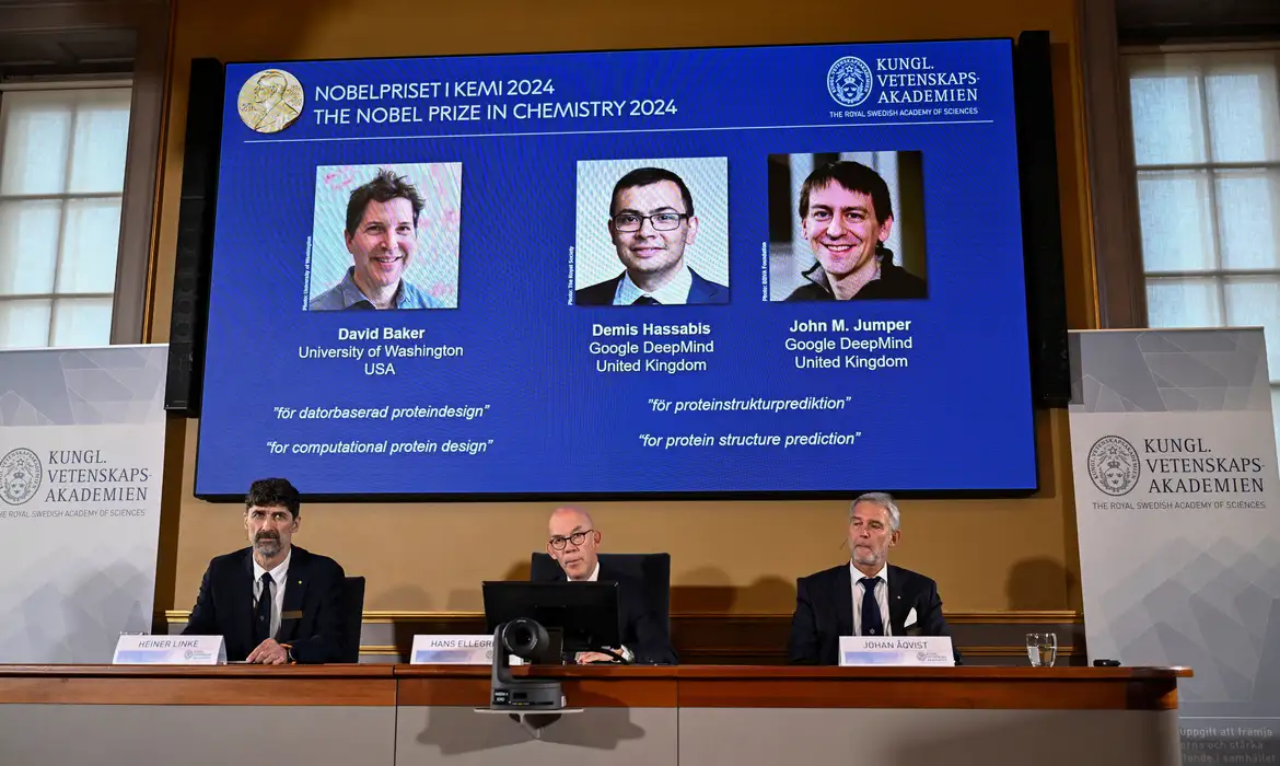 Announcers of the laureates for the Nobel Prize in Chemistry, Johan Aqvist, Hans Ellegren and Heiner Linke, look on as the images of the winners, David Baker (University of Washington, USA), Demis Hassabis (Google DeepMind, UK) and John M Jumper (Google DeepMind, UK) are displayed, in Stockholm, Sweden October 9, 2024. TT News Agency/Christine Olsson via REUTERS      ATTENTION EDITORS - THIS IMAGE WAS PROVIDED BY A THIRD PARTY. SWEDEN OUT. NO COMMERCIAL OR EDITORIAL SALES IN SWEDEN.